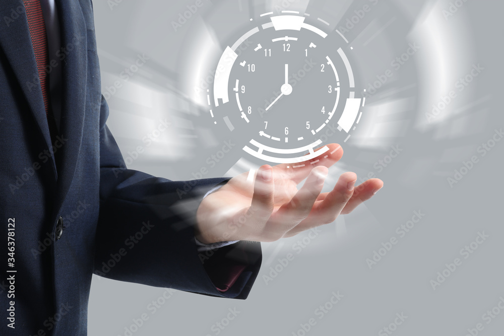 Businessman with virtual clock on grey background. Time management concept