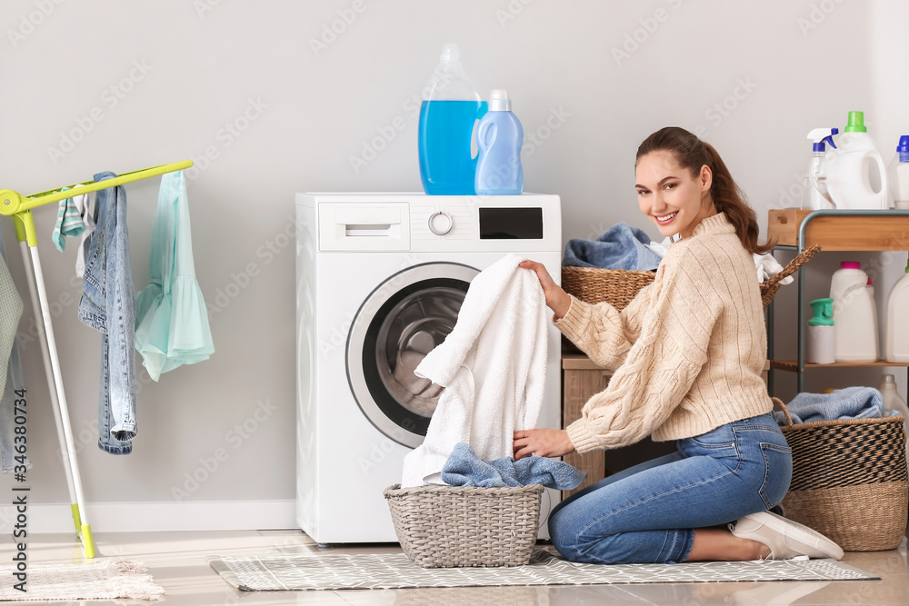 Young woman doing laundry at home