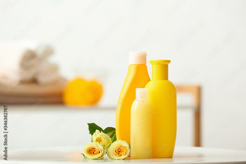 Different shower gels on table in bathroom