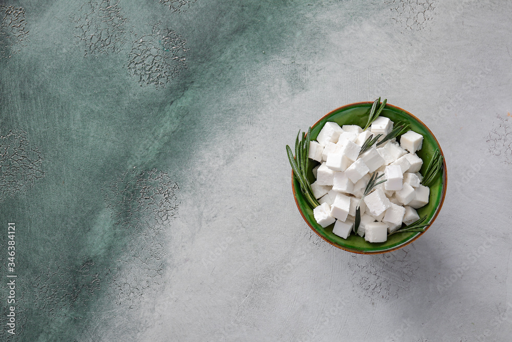 Bowl with tasty cut feta cheese on table