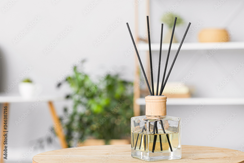 Reed diffuser on table in room