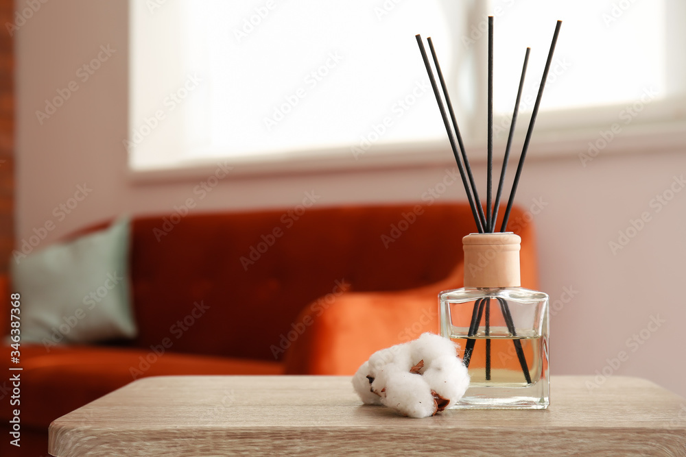 Reed diffuser on table in room