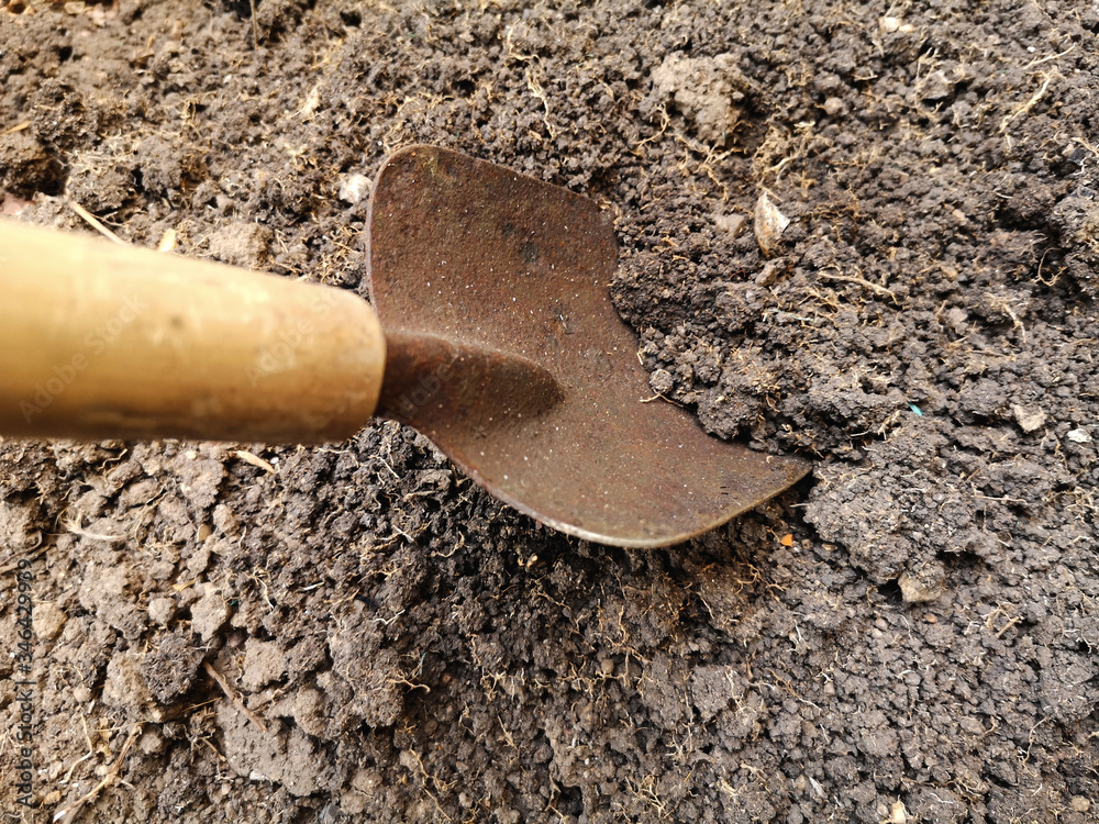 Shoveling the soil for gardening in soft focus and good soil for planting.