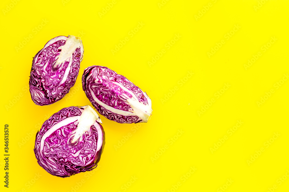 Red cabbage on yellow table top down copy space