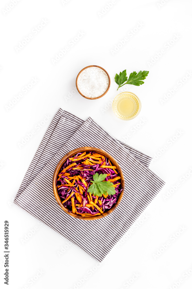 Healthy vegan salad with red cabbage - coleslaw - on white desk top-down