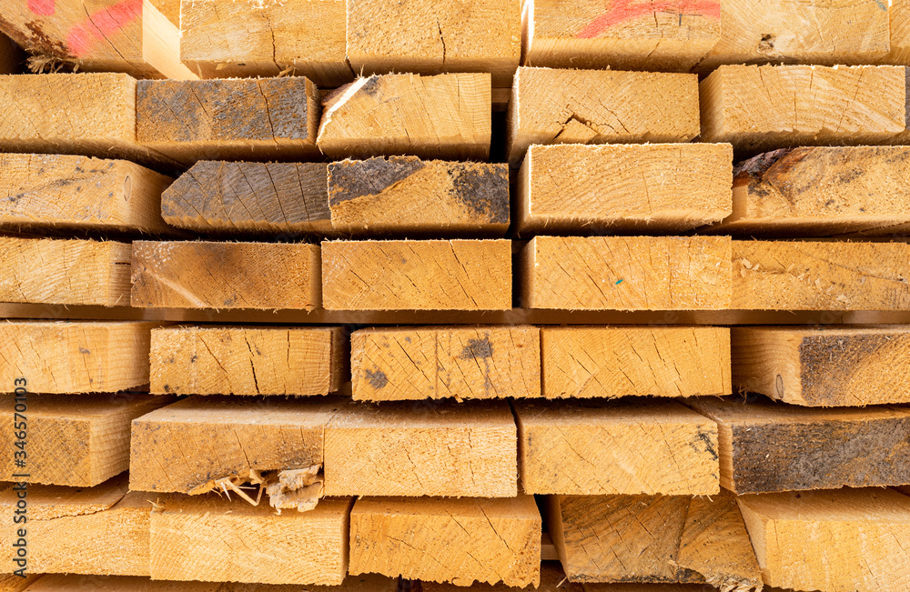 Stack of lumber wooden beams prepared to build a house