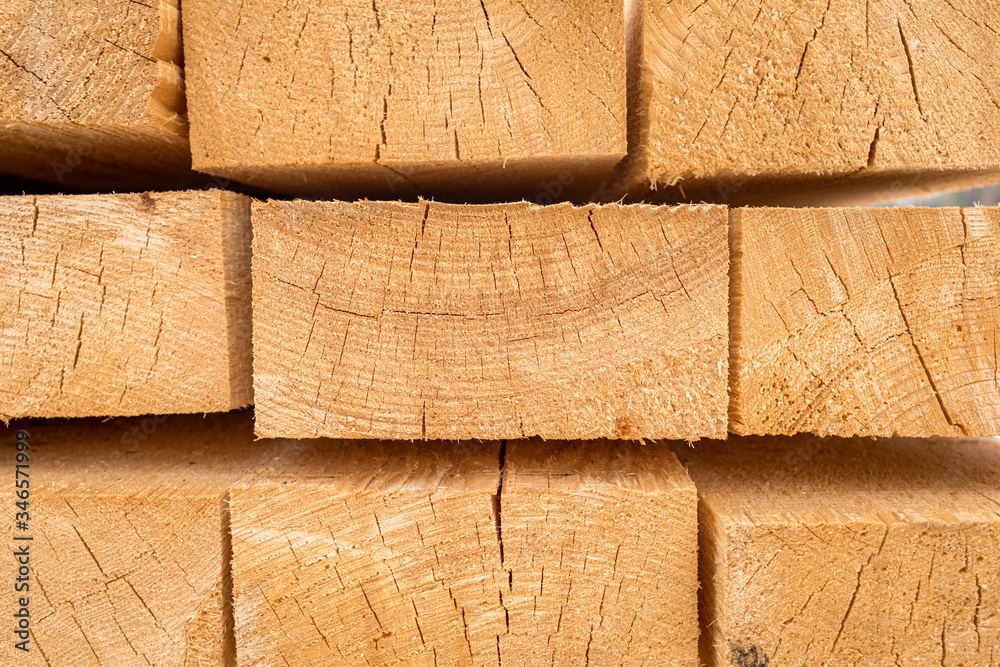 Stack of construction wood planks prepared for build a house