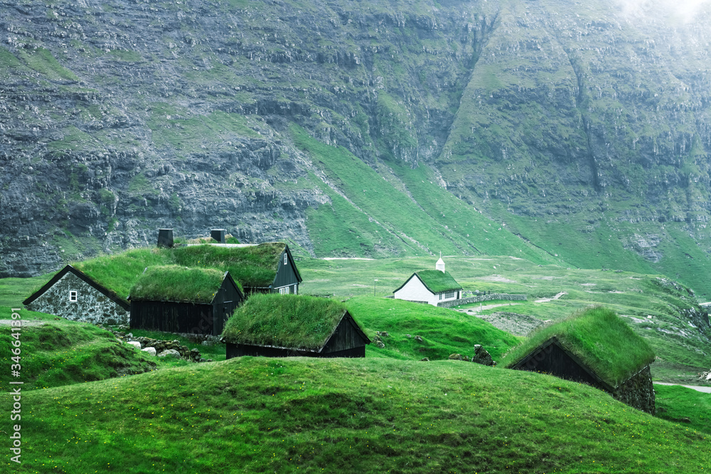 Summer view of traditional turf-top church Saksunar Kirkja in Saksun village. Beauty landscape with 