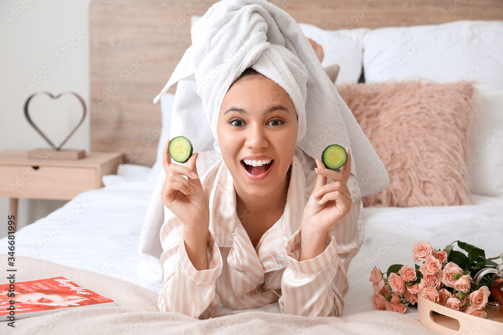 Morning of beautiful young African-American woman taking care of her skin at home