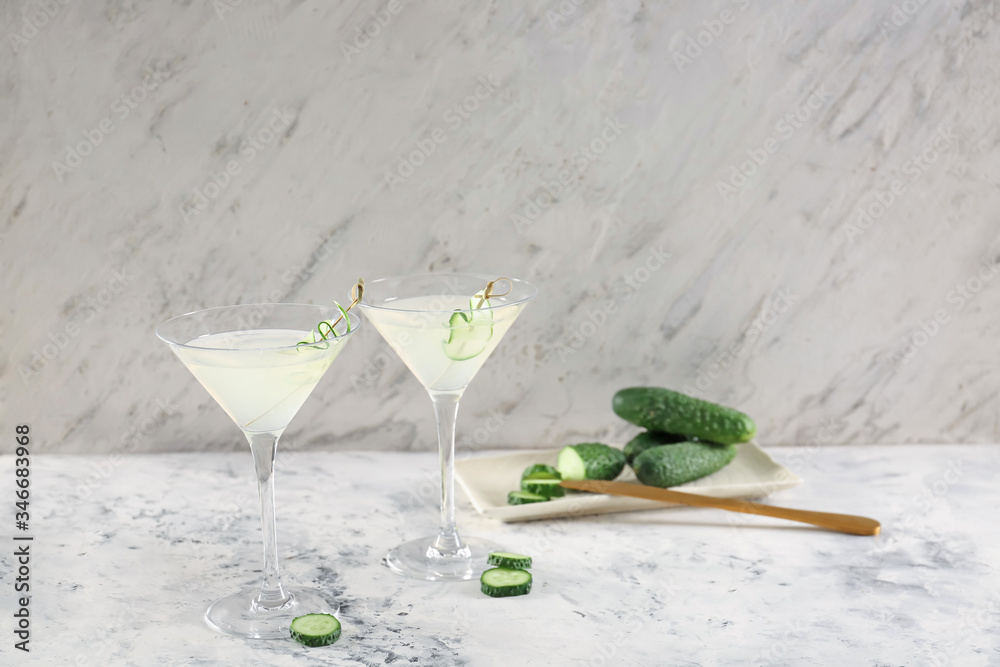 Glasses of tasty cucumber martini on table