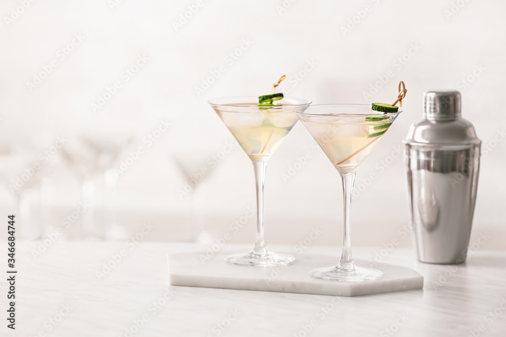 Glasses of tasty cucumber martini on table