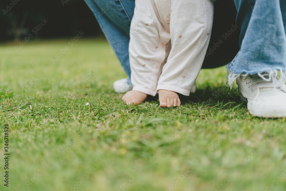 baby walking on grass