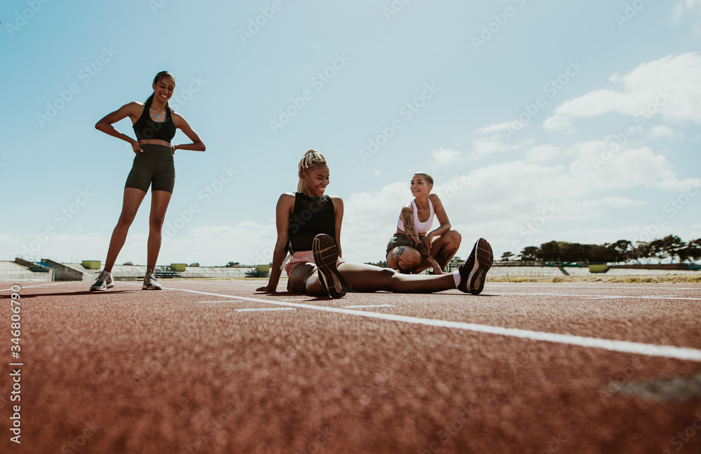 Group of female runners relaxing after workout