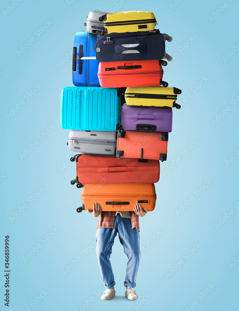 A tourist holds a huge pile of suitcases, a tourist concept