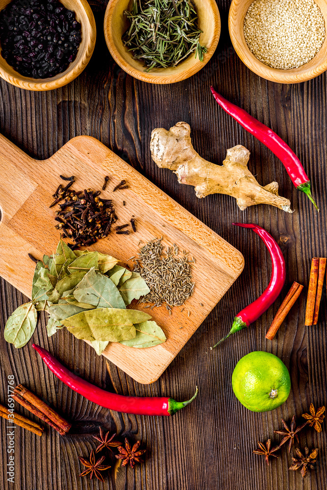 Dry colorful spices, chili pepper on kitchen wooden table background top view