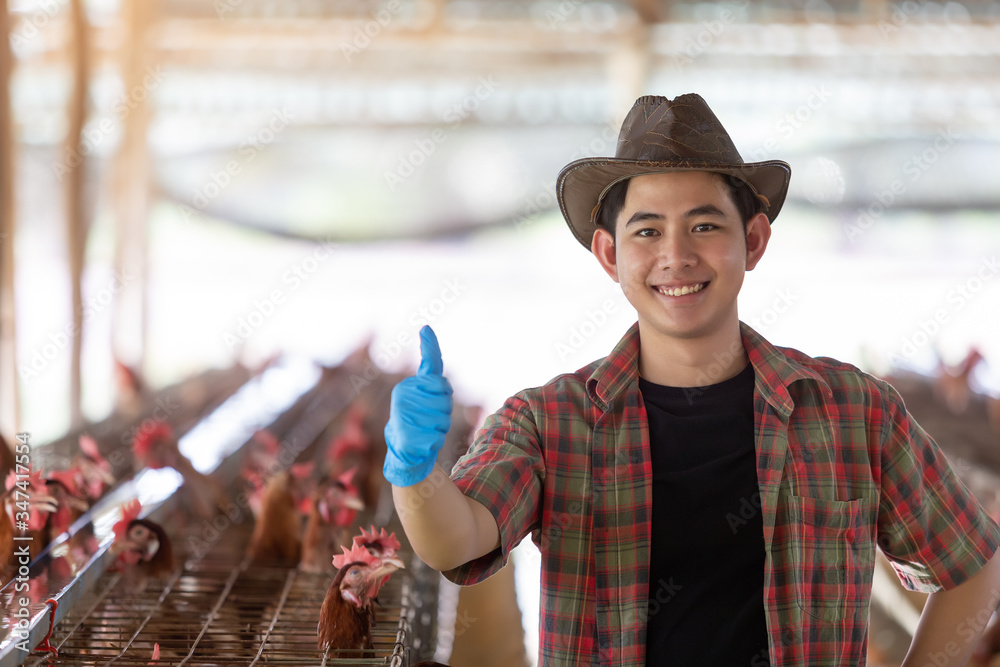 Portrait of young asian man farmer in Eggs chicken farm.