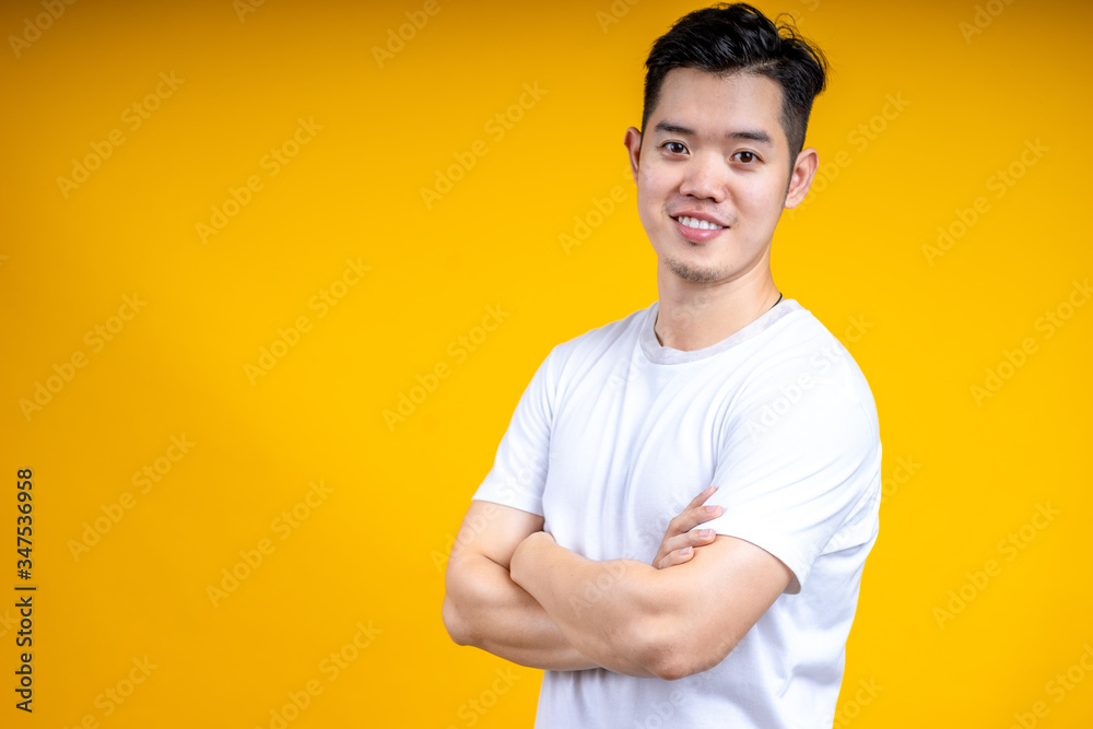 Young Asian man wearing posting isolate on yellow background. Happiness, model.