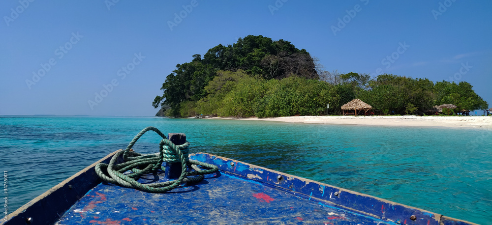 Boat on emerald blue sea water