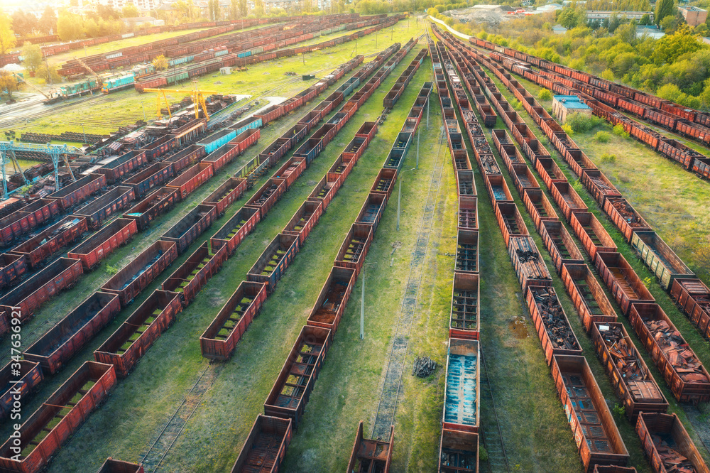 Aerial view of freight trains. Top view of old rusty wagons on railroad. Heavy industry. Industrial 