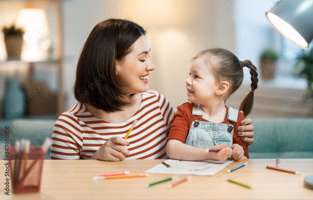 Mother and daughter are painting together