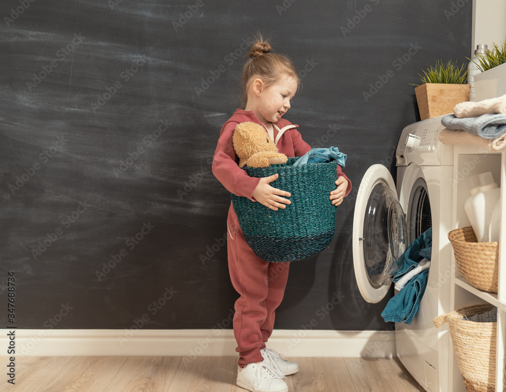 girl is doing laundry at home.