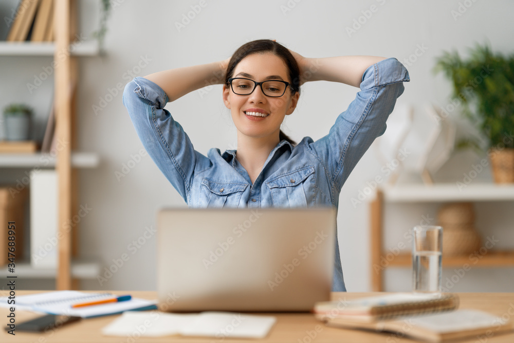 woman working on a laptop at home.