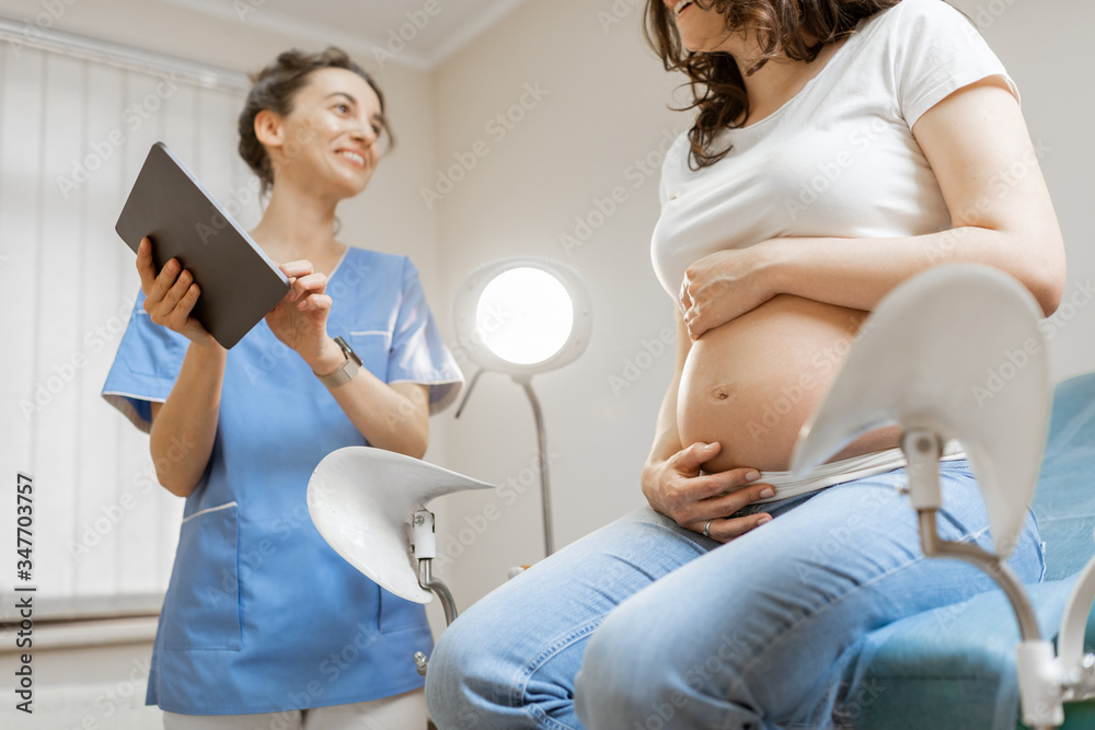 Nurse with pregnant woman during a medical consultation in gynecological office. Concept of medical 