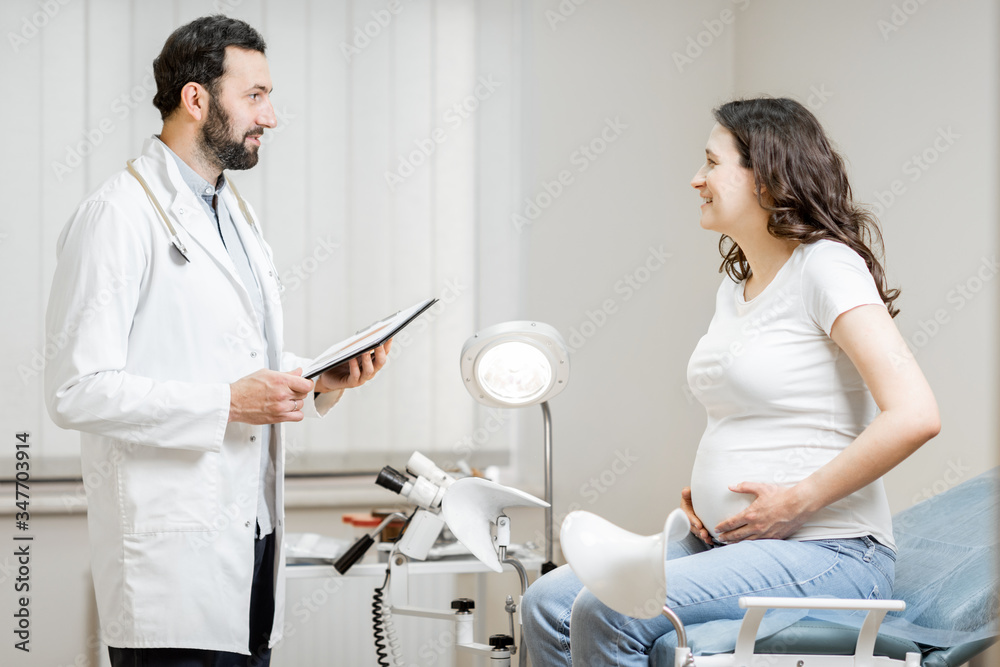 Doctor with pregnant woman during a medical consultation in gynecological office. Concept of medical