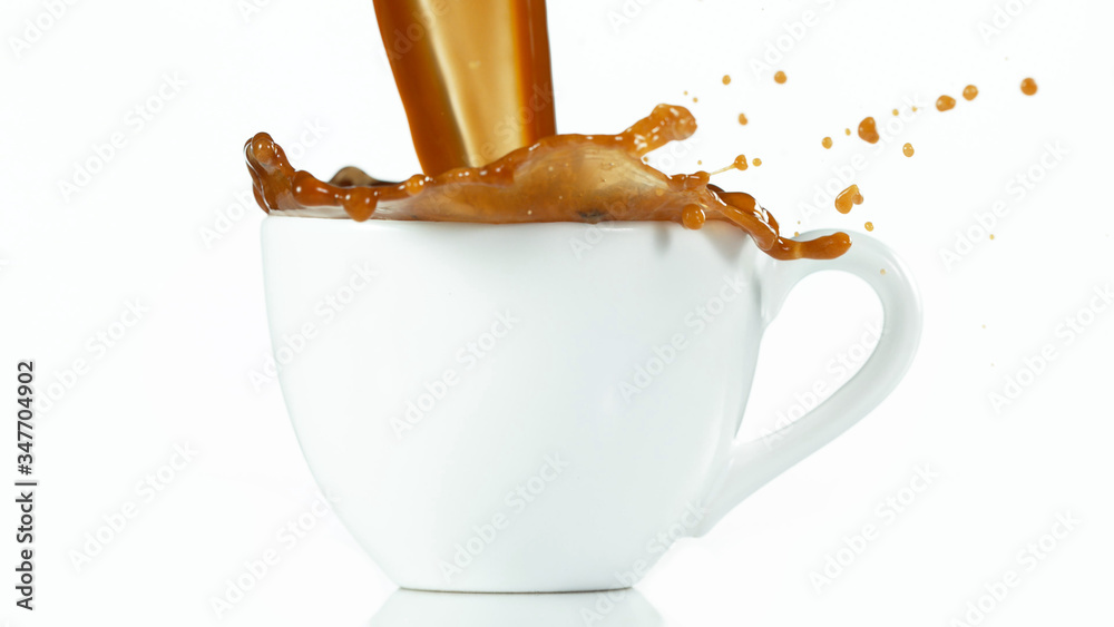 A cup with a large splash of coffee.