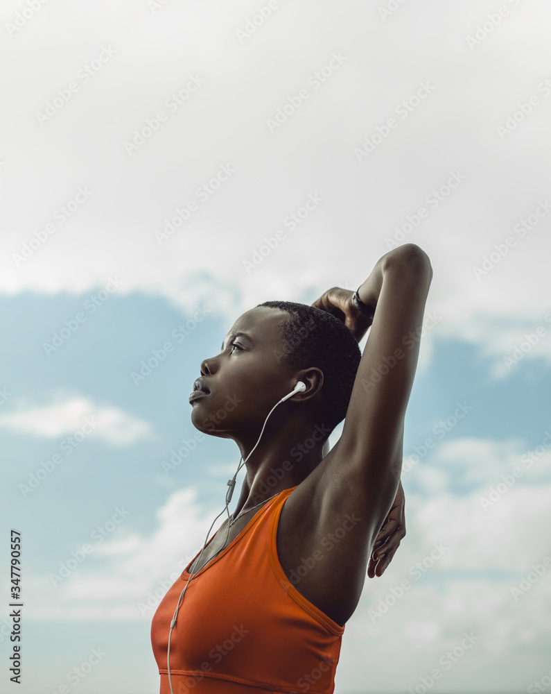 Female in sportswear doing arms stretches