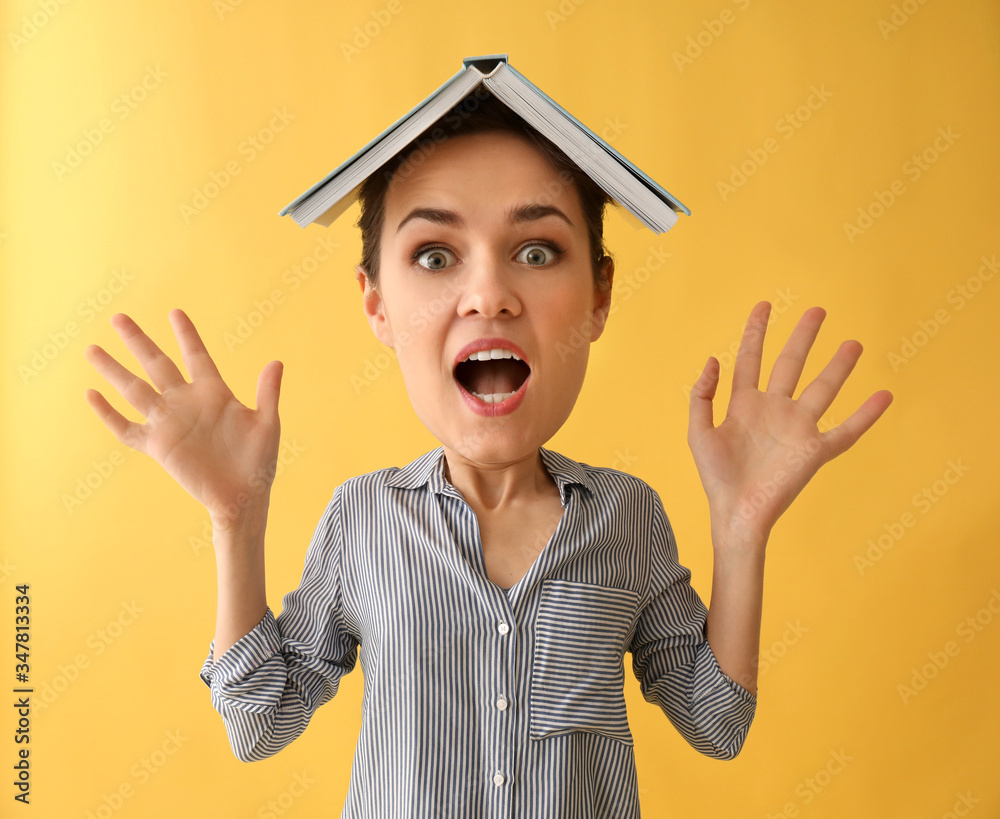 Stressed female student with big head on color background