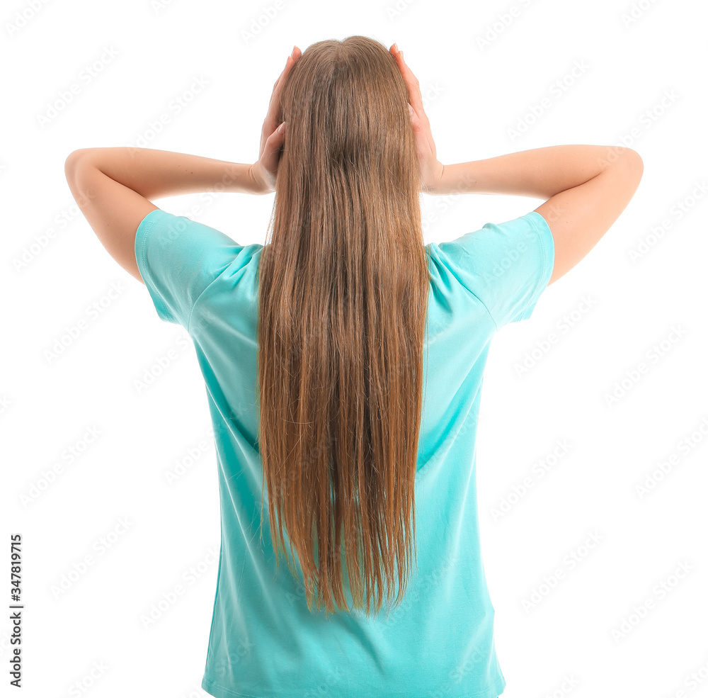 Young woman suffering from loud noise on white background