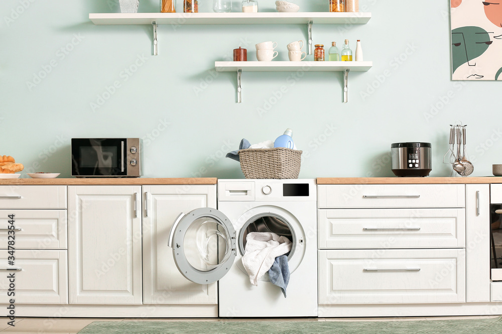 Interior of kitchen with modern washing machine