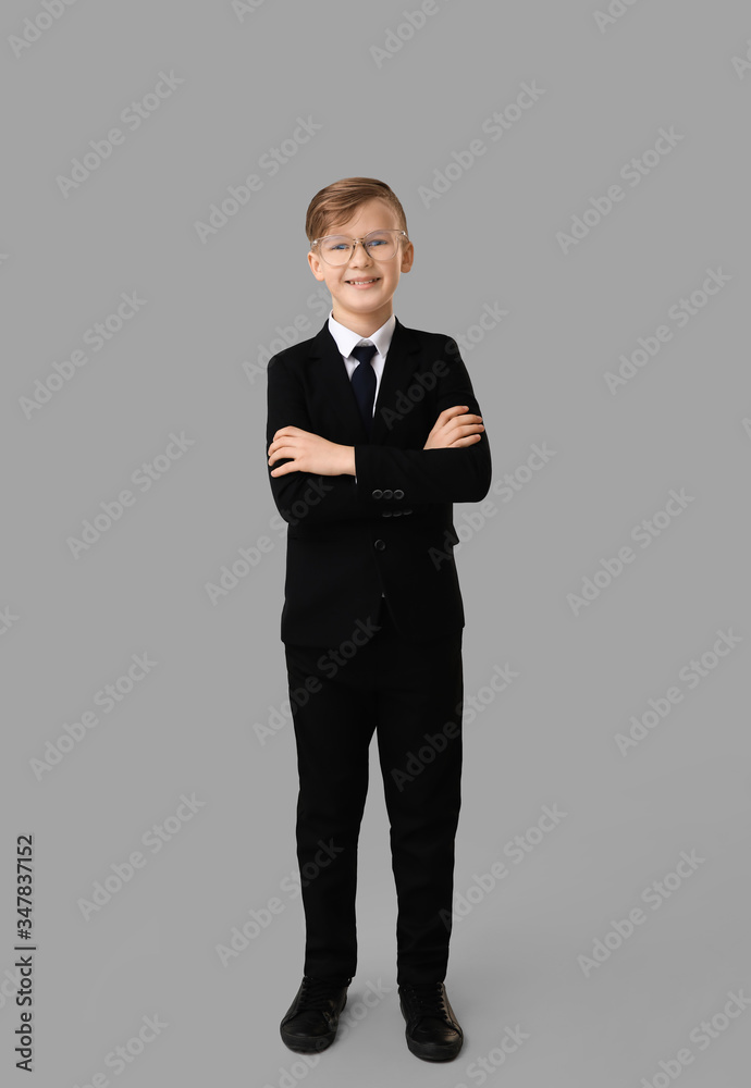 Portrait of little secretary on grey background