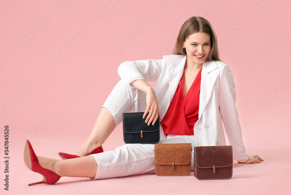 Beautiful woman with stylish bags on color background