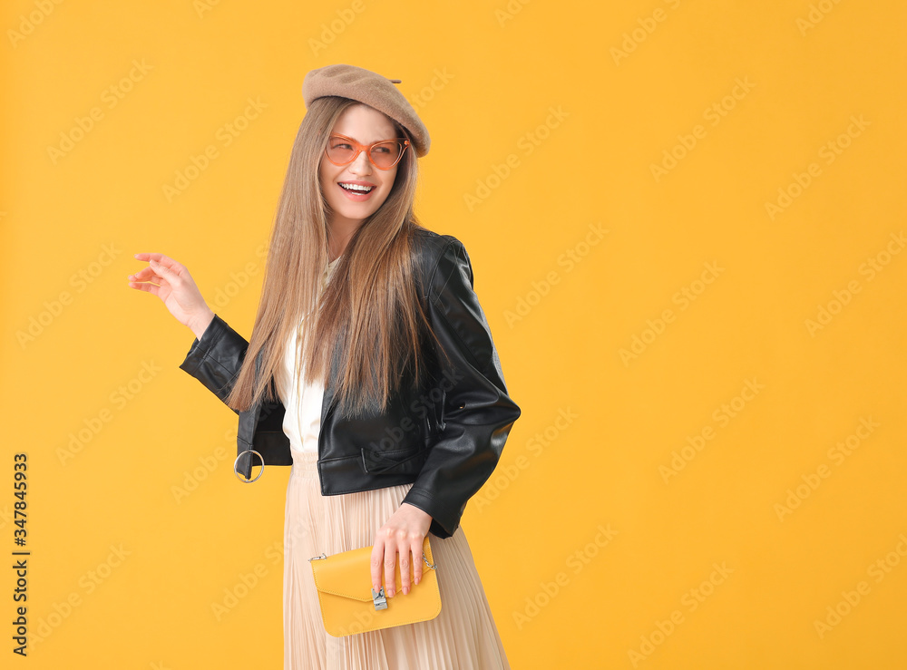 Beautiful woman with stylish bag on color background