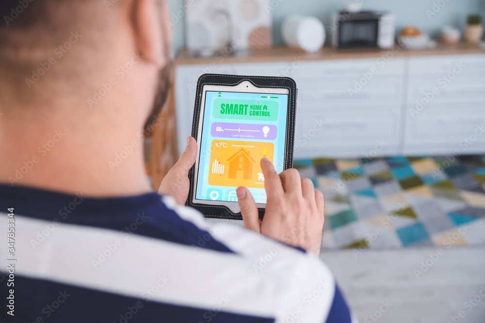 Man using application of smart home automation