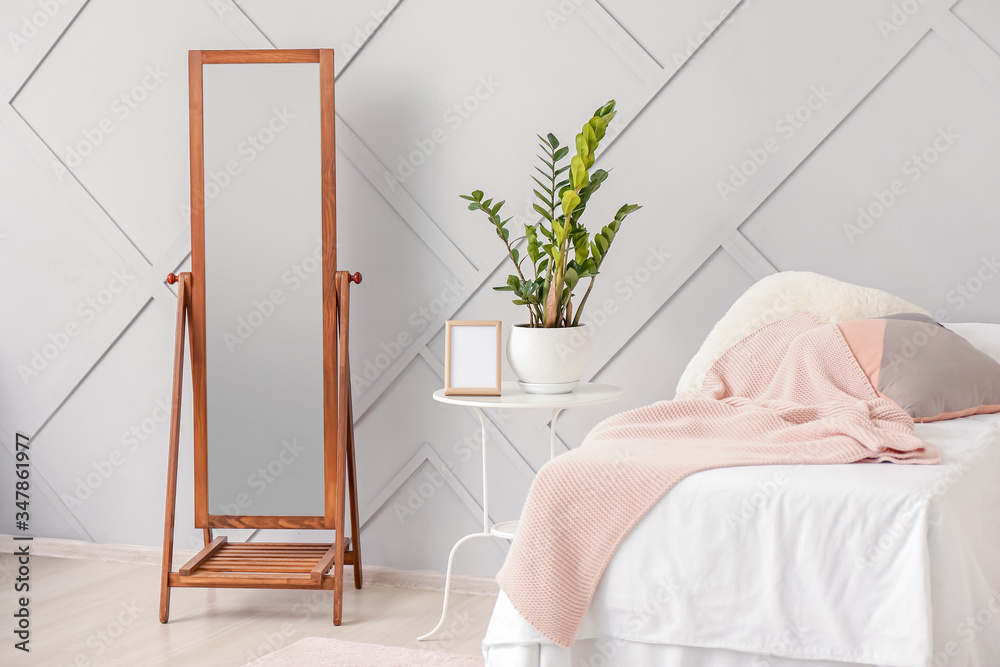 Interior of modern bedroom with big mirror