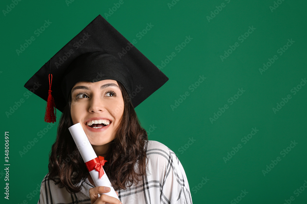 Female graduating student with diploma on color background