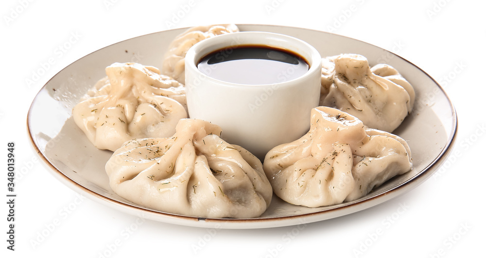 Plate with tasty dumplings on white background