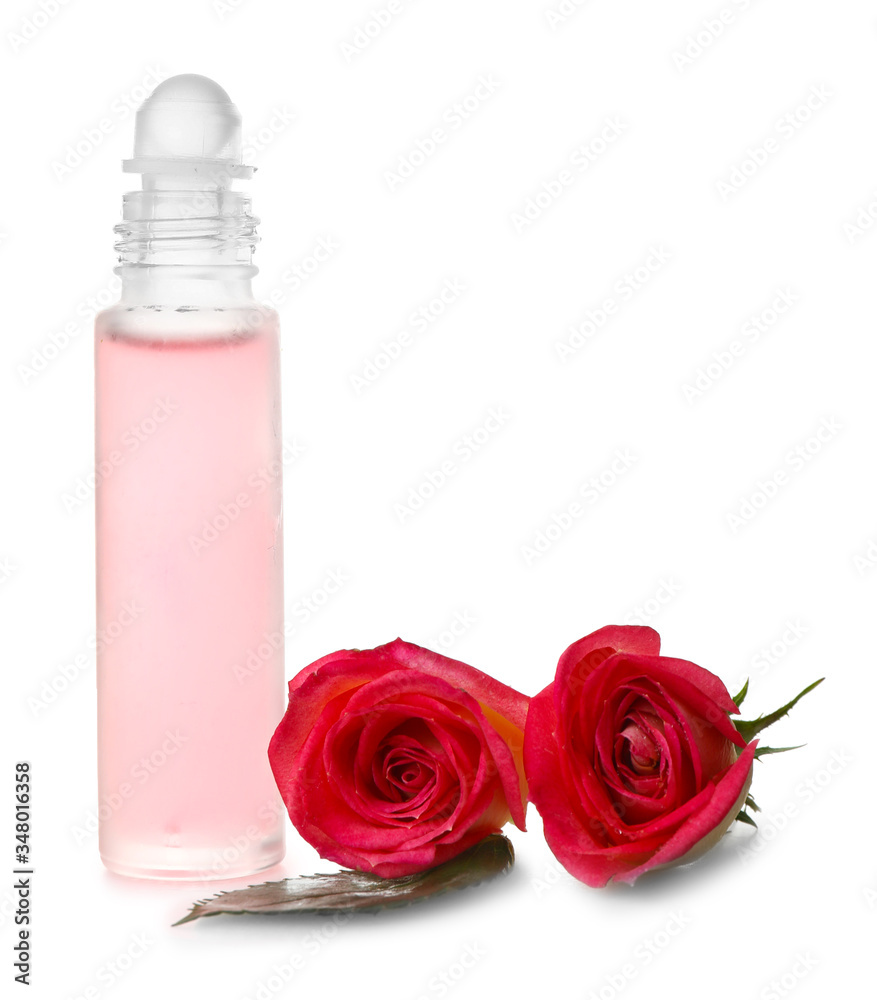 Bottle of floral roll-on perfume on white background