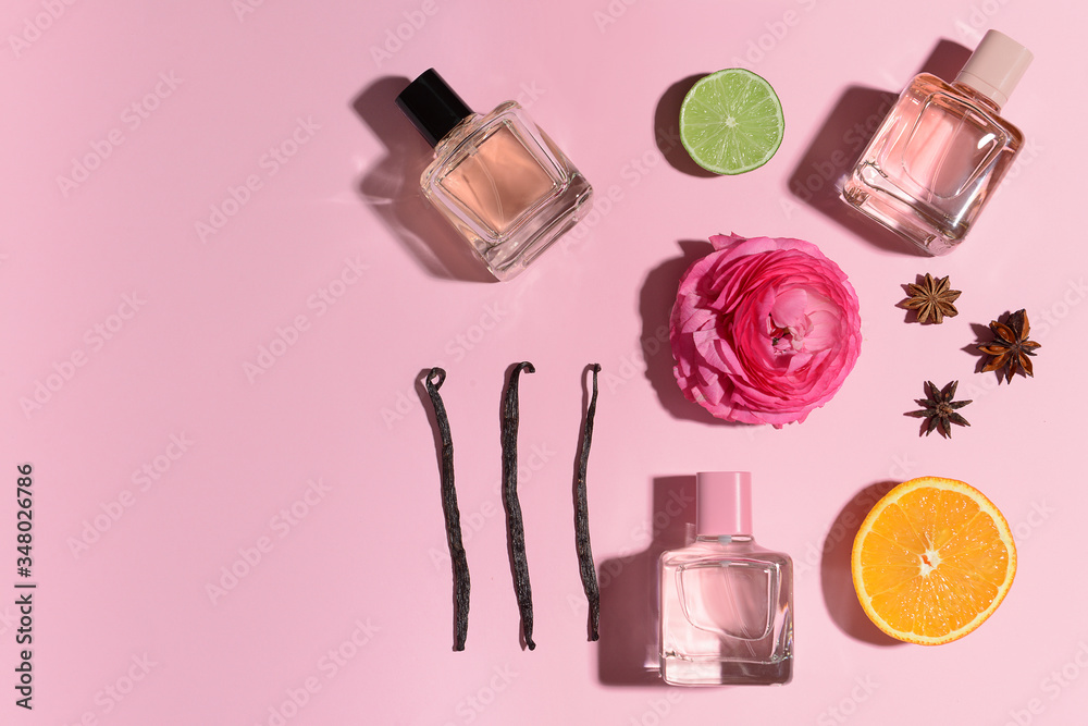 Beautiful composition with perfume bottles on color background