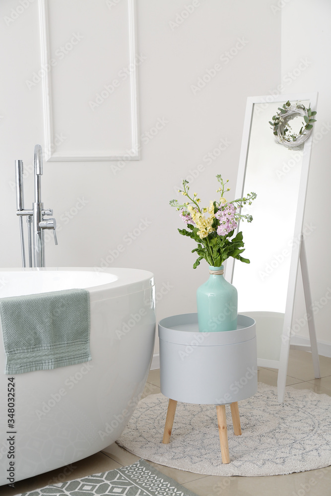 Interior of bathroom with fresh flowers