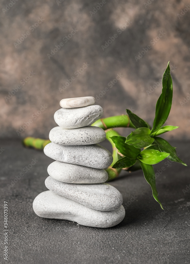 Stack of spa stones on grey background