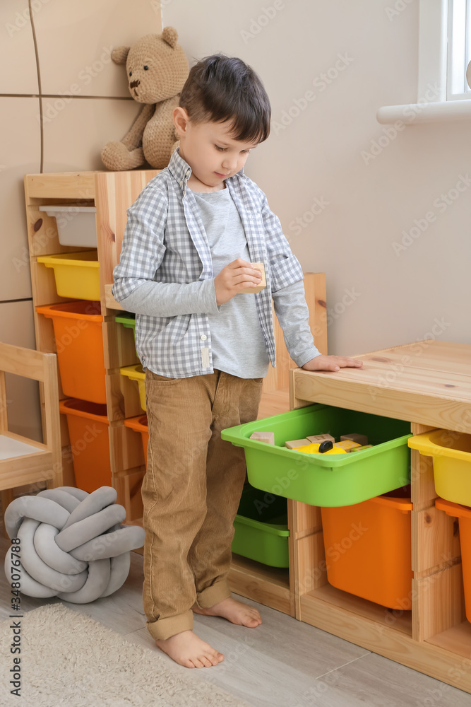 Little boy with toys at home