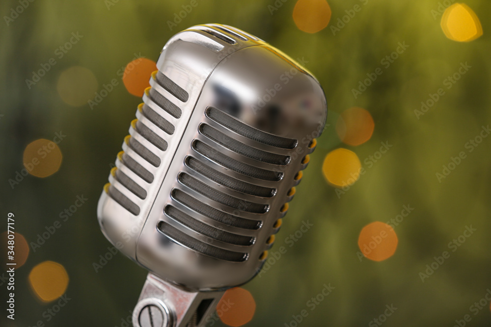 Retro microphone on dark background with blurred lights