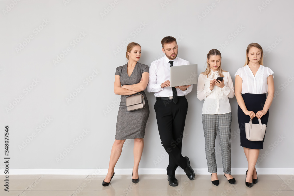 Business people waiting in line indoors