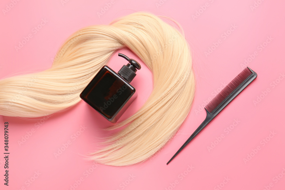 Long blonde hair, shampoo and comb on color background