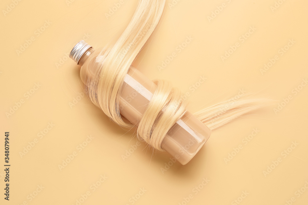 Bottle of shampoo for blonde hair on color background