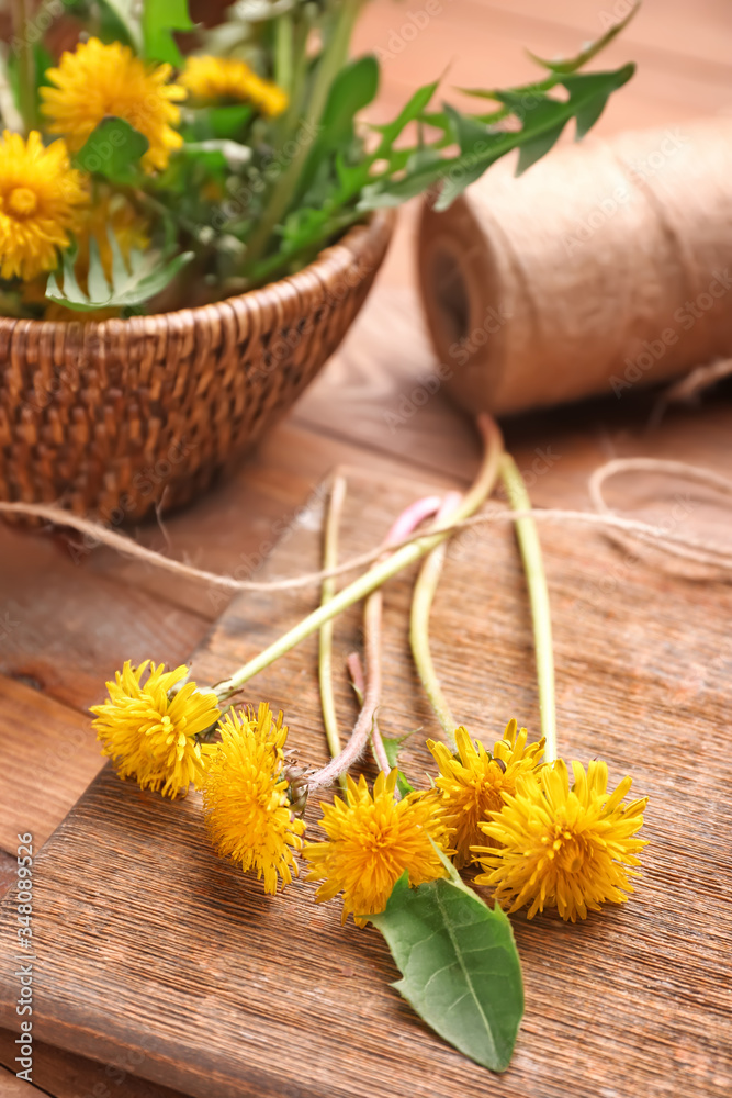 Beautiful dandelions on wooden background